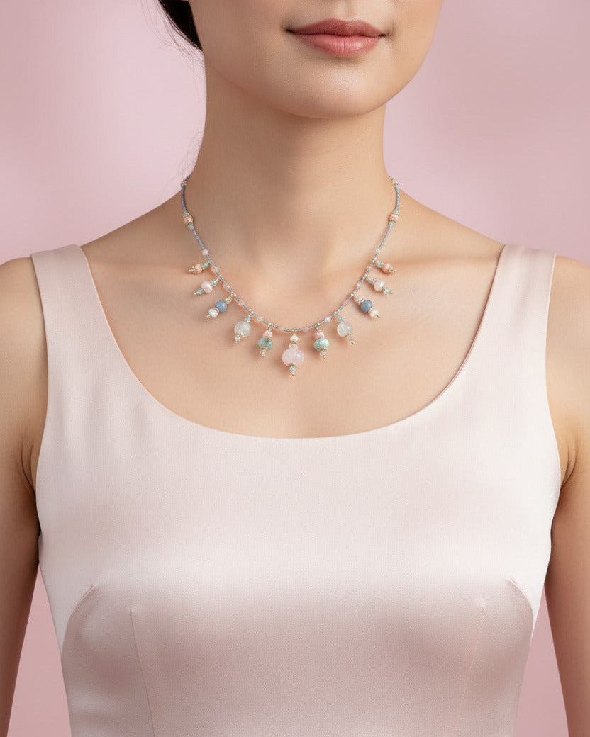 Bijou Prishaara porté, révélant les nuances bleu-glacé et rose tendre des minéraux.