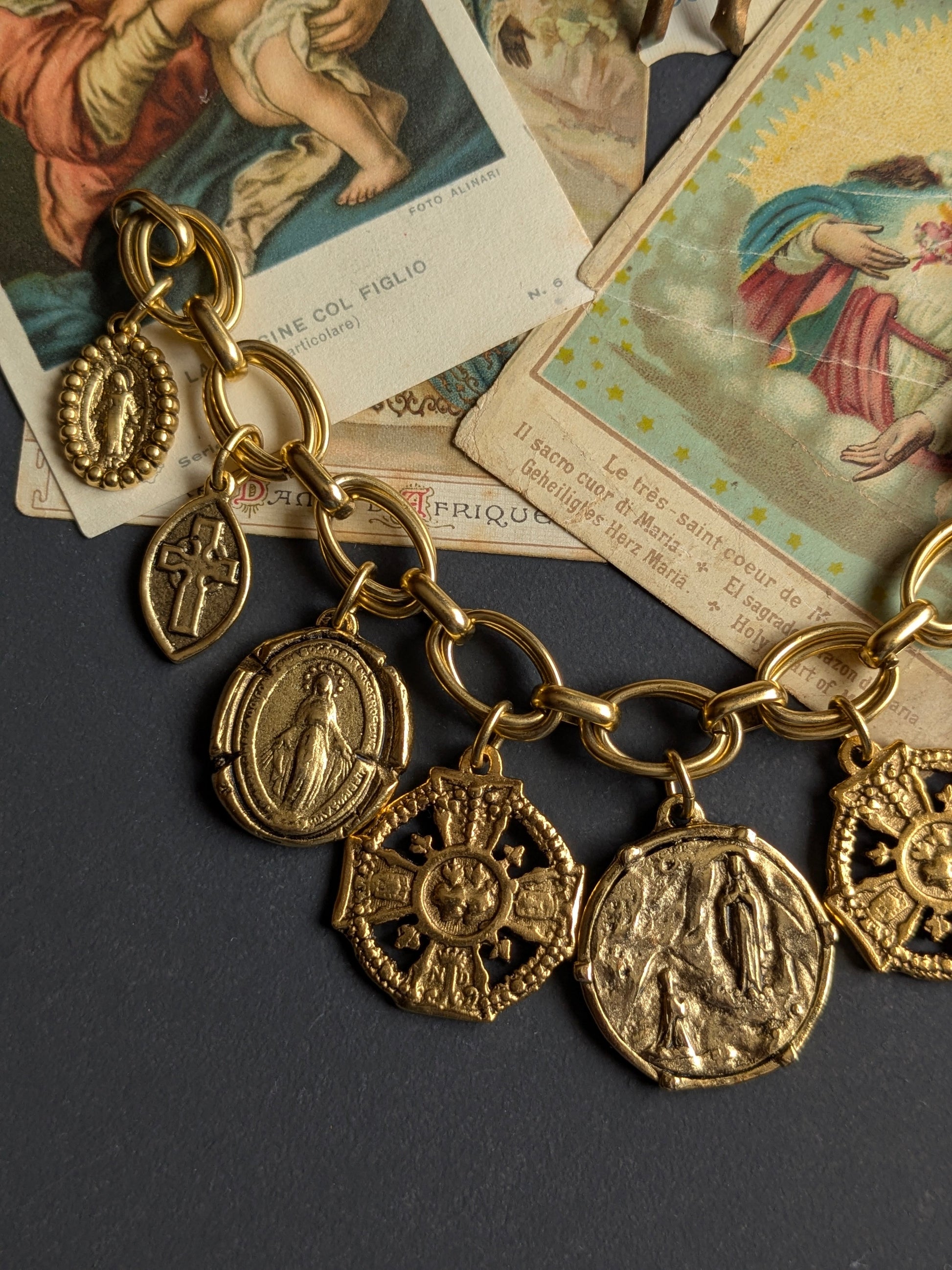 Détail du Cœur Sacré réversible et de la Médaille Miraculeuse sur le bracelet Neuvaine, laiton plaqué or 12kt.